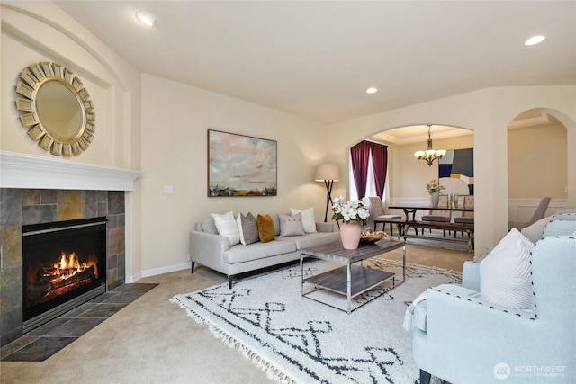 24826 SE 22nd Ct, Sammamish, WA 98075 - living area with arched walkways, a fireplace, carpet, recessed lighting, and a chandelier