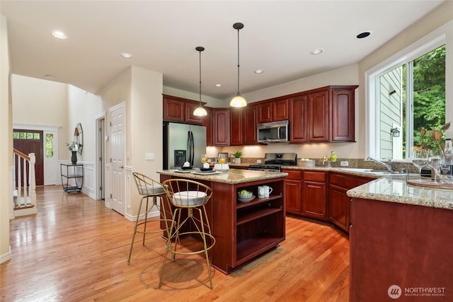 24826 SE 22nd Ct, Sammamish, WA 98075 - kitchen featuring stainless steel appliances, open shelves, light stone counters, light wood-style floors, and recessed lighting
