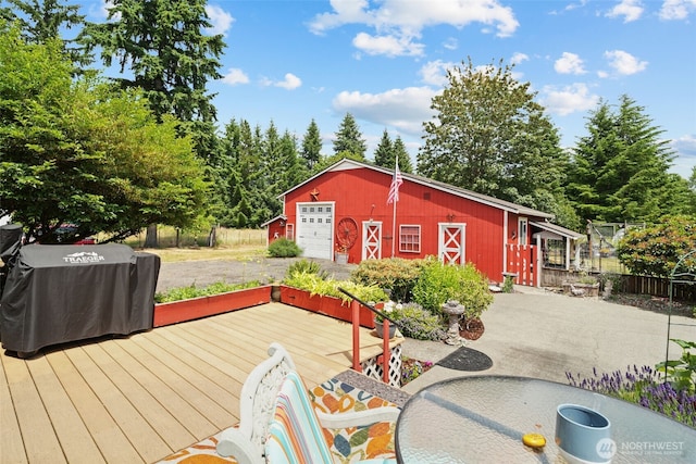 6338 Kirsop, Olympia, WA 98512 - wooden deck featuring an outbuilding, area for grilling, a garage, and driveway