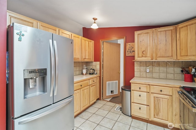 6338 Kirsop, Olympia, WA 98512 - kitchen featuring appliances with stainless steel finishes, light brown cabinets, light countertops, light tile patterned floors, and backsplash