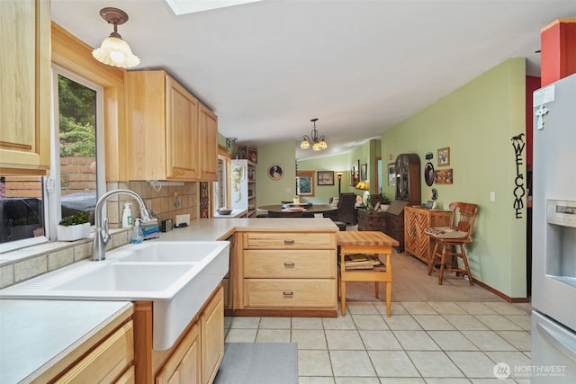 6338 Kirsop, Olympia, WA 98512 - kitchen with a chandelier, light brown cabinetry, light countertops, white fridge with ice dispenser, and light tile patterned flooring