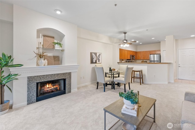 9229 122nd Ct NE Unit C-13, Kirkland, WA 98033 - living room with light colored carpet, a fireplace, a ceiling fan, and recessed lighting