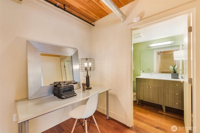 530 Broadway E Unit 130, Seattle, WA 98102 - office area with wood finished floors and a wooden ceiling with exposed beams