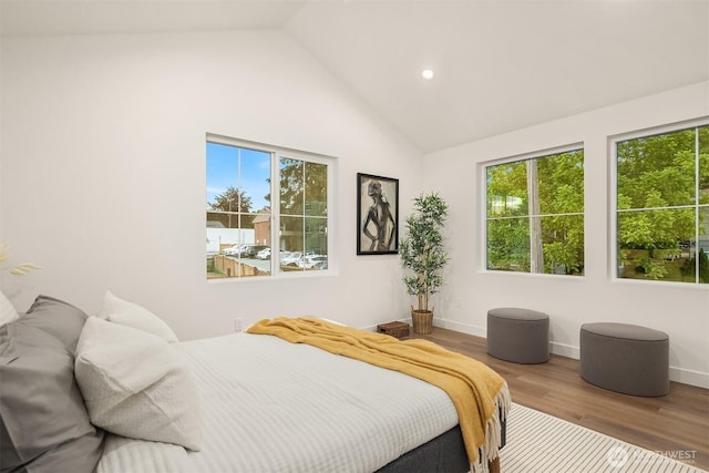 9224 36th Ave SW Unit 2, Seattle, WA 98126 - bedroom featuring multiple windows, high vaulted ceiling, wood finished floors, and recessed lighting