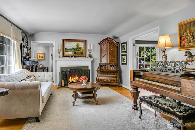 16525 39th Ave NE, Lake Forest Park, WA 98155 - living room featuring vaulted ceiling, light wood-style floors, and a lit fireplace