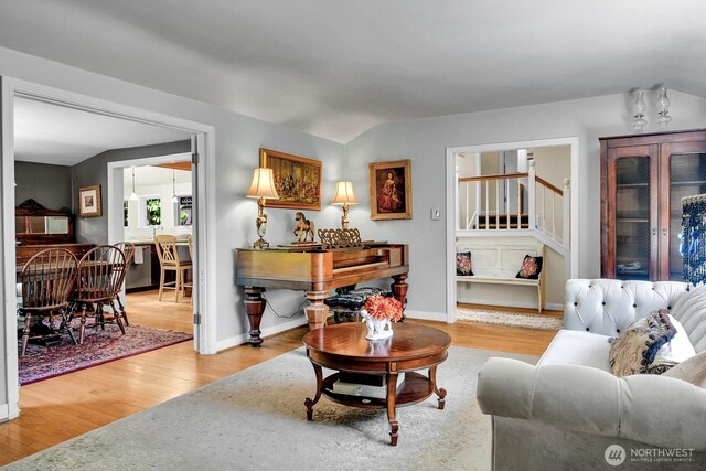 16525 39th Ave NE, Lake Forest Park, WA 98155 - living room featuring wood finished floors, vaulted ceiling, and stairs