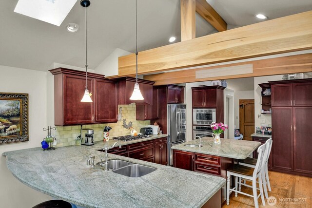 16525 39th Ave NE, Lake Forest Park, WA 98155 - kitchen with dark brown cabinets, appliances with stainless steel finishes, a skylight, decorative backsplash, and recessed lighting
