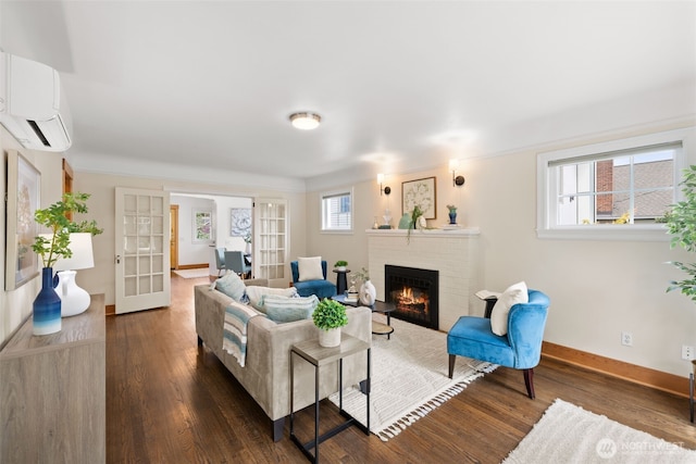 6427 Flora Ave S, Seattle, WA 98108 - living area featuring dark wood finished floors, a brick fireplace, and an AC wall unit