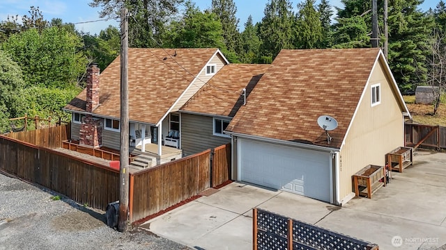 6621 125th Street Ct E, Puyallup, WA 98373 - view of front facade with roof with shingles, concrete driveway, a chimney, and an attached garage