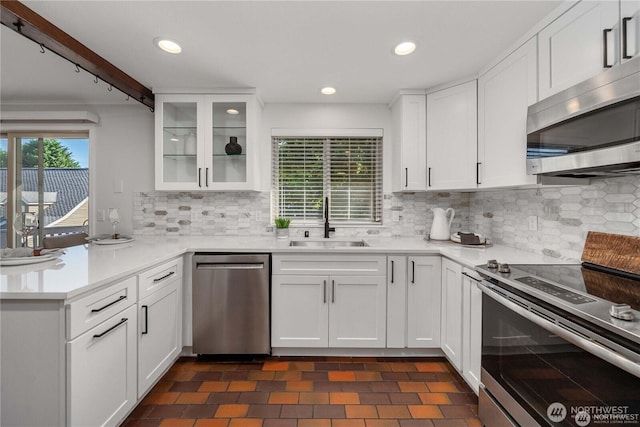 20873 2nd Pl SW, Normandy Park, WA 98166 - kitchen featuring stainless steel appliances, a peninsula, white cabinetry, glass insert cabinets, and light countertops
