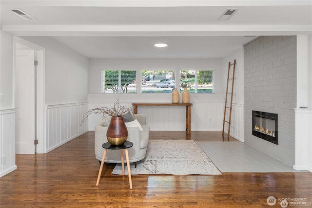 20873 2nd Pl SW, Normandy Park, WA 98166 - living area with wood finished floors, a wainscoted wall, a fireplace, a decorative wall, and recessed lighting
