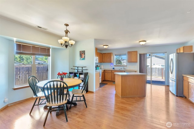 109 Nelsen St NE, Orting, WA 98360 - dining space featuring light wood-style flooring and a chandelier
