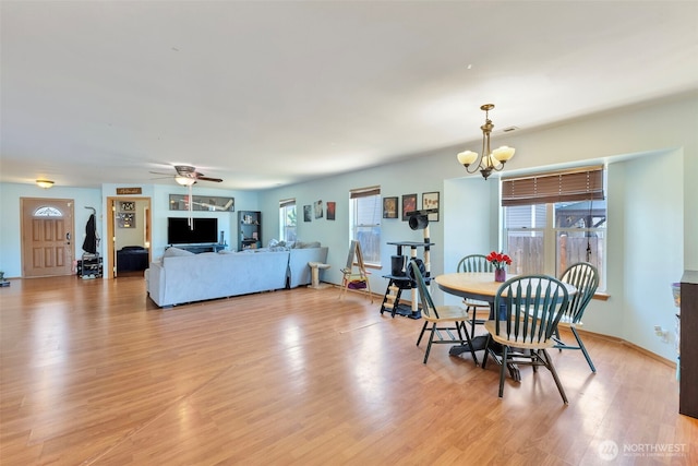 109 Nelsen St NE, Orting, WA 98360 - dining space featuring a chandelier, plenty of natural light, light wood-style flooring, and ceiling fan
