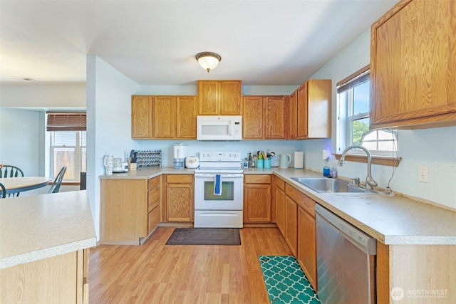 109 Nelsen St NE, Orting, WA 98360 - kitchen featuring white appliances, light wood-style floors, and light countertops