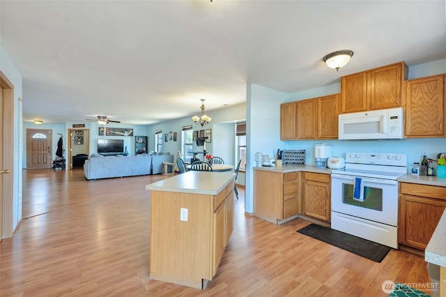 109 Nelsen St NE, Orting, WA 98360 - kitchen with white appliances, light countertops, and light wood-type flooring