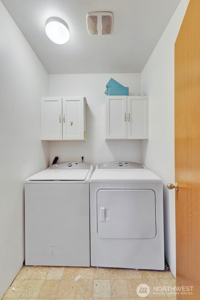 109 Nelsen St NE, Orting, WA 98360 - washroom featuring cabinet space and independent washer and dryer