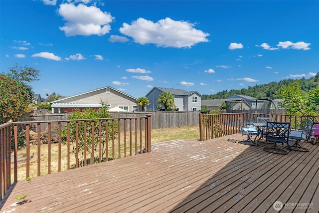 109 Nelsen St NE, Orting, WA 98360 - wooden terrace with a fenced backyard, a residential view, and outdoor dining space