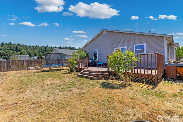 109 Nelsen St NE, Orting, WA 98360 - back of house with a trampoline and a deck