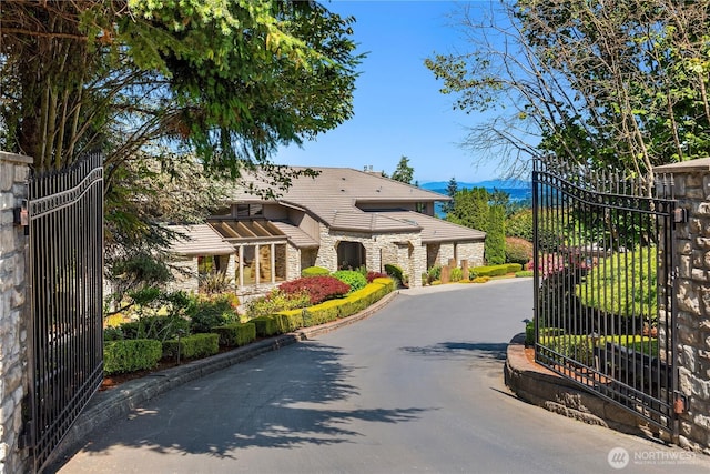 6411 View St NE, Tacoma, WA 98422 - view of asphalt driveway with a gate, a gated entry, and a mountain view