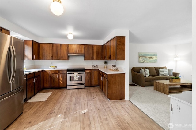 4530 Vacca Ln, Bellingham, WA 98226 - kitchen with stainless steel appliances, open floor plan, light countertops, light wood-style flooring, and under cabinet range hood