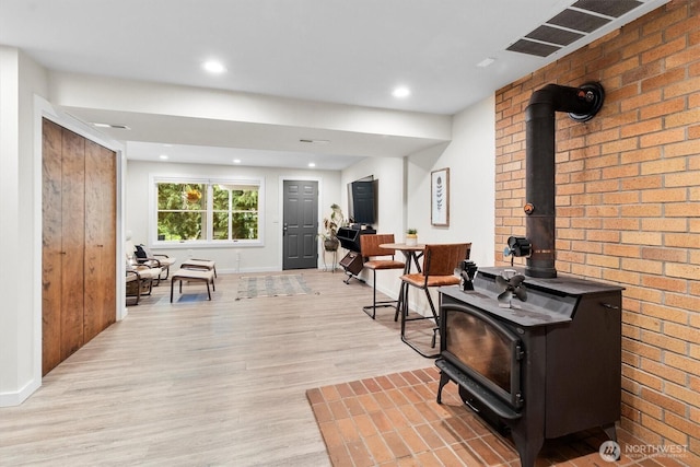 4530 Vacca Ln, Bellingham, WA 98226 - interior space with a wood stove, light wood-type flooring, recessed lighting, and brick wall