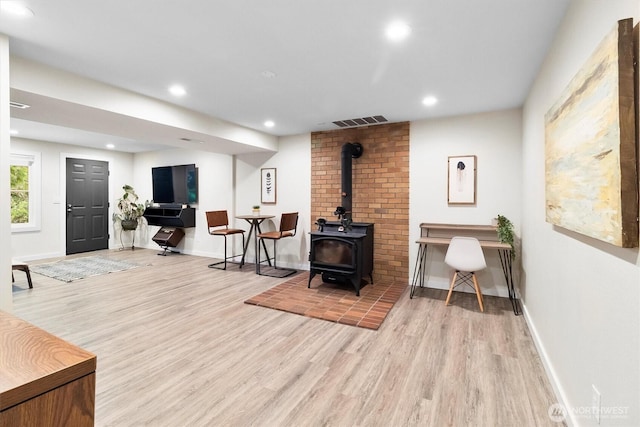 4530 Vacca Ln, Bellingham, WA 98226 - living room with wood finished floors, a wood stove, and recessed lighting