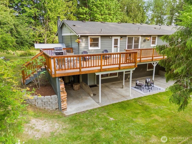 4530 Vacca Ln, Bellingham, WA 98226 - back of property with a patio, a wooden deck, a yard, and a shingled roof