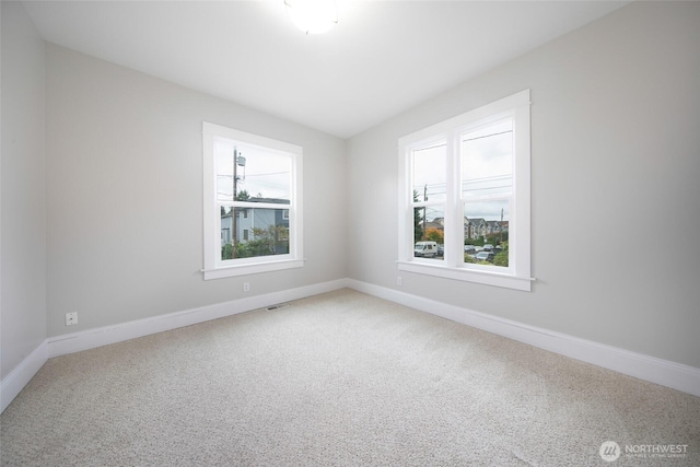 6753 14th Ave NW, Seattle, WA 98117 - unfurnished room featuring light carpet and baseboards