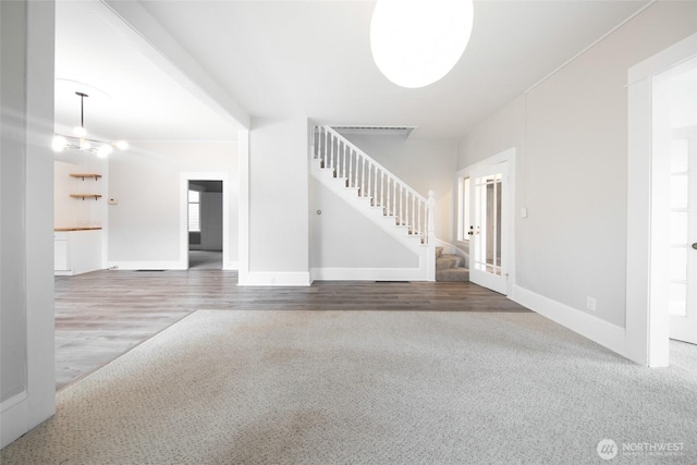 6753 14th Ave NW, Seattle, WA 98117 - unfurnished living room featuring stairway and baseboards