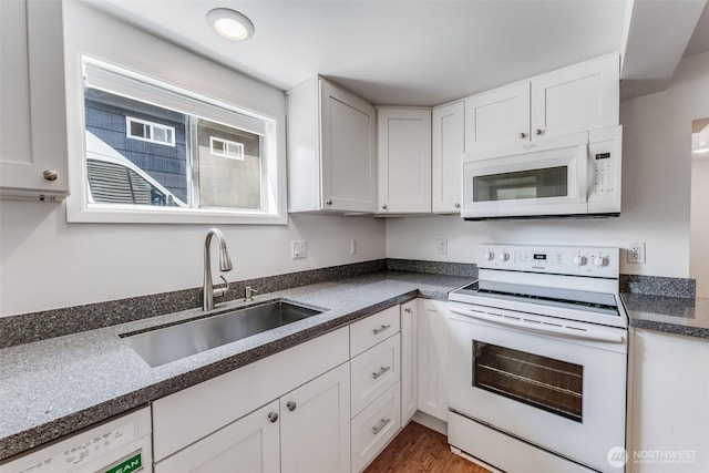6753 14th Ave NW, Seattle, WA 98117 - kitchen featuring white appliances, white cabinetry, and dark countertops
