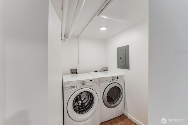 6753 14th Ave NW, Seattle, WA 98117 - laundry room featuring electric panel, washer and clothes dryer, and light wood-type flooring