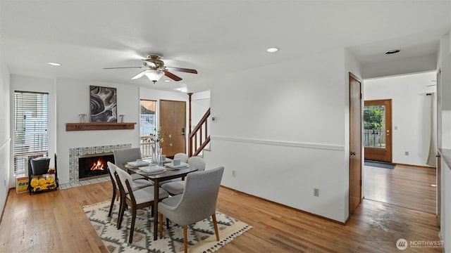 5109 S Myrtle St, Seattle, WA 98118 - dining space with plenty of natural light, a tile fireplace, light wood-style flooring, stairway, and recessed lighting
