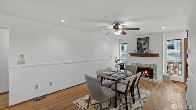 5109 S Myrtle St, Seattle, WA 98118 - dining area featuring a tile fireplace, light wood finished floors, ceiling fan, and recessed lighting