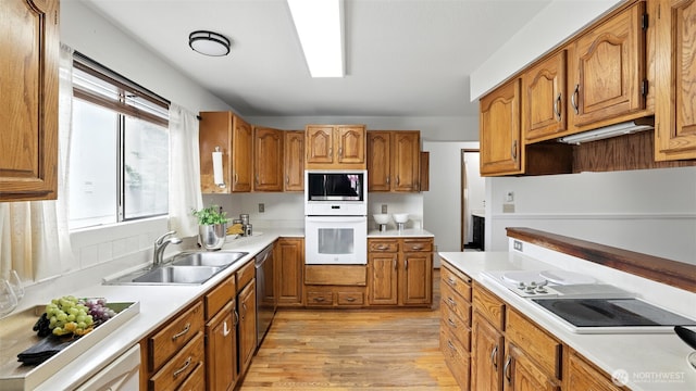 5109 S Myrtle St, Seattle, WA 98118 - kitchen featuring white appliances, brown cabinetry, light wood-style flooring, and light countertops