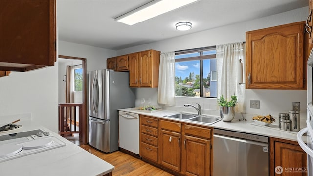 5109 S Myrtle St, Seattle, WA 98118 - kitchen with stainless steel appliances, brown cabinetry, light countertops, and light wood-style floors