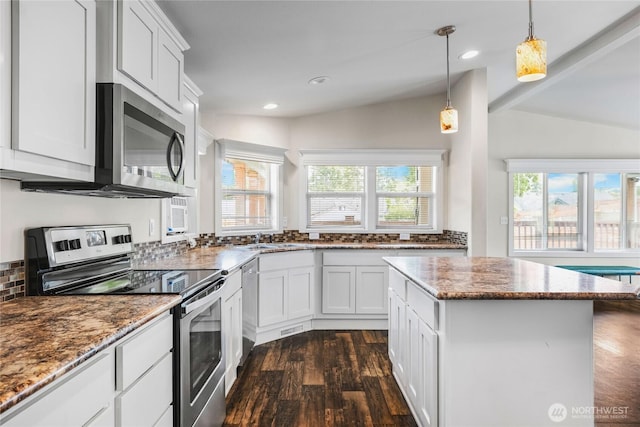 120 L St SE, Auburn, WA 98002 - kitchen with stainless steel appliances, dark wood-style floors, light stone counters, a kitchen island, and recessed lighting