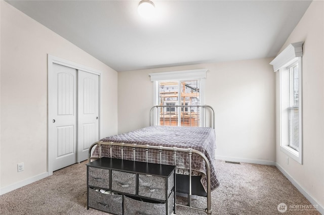 120 L St SE, Auburn, WA 98002 - carpeted bedroom featuring multiple windows, lofted ceiling, and a closet