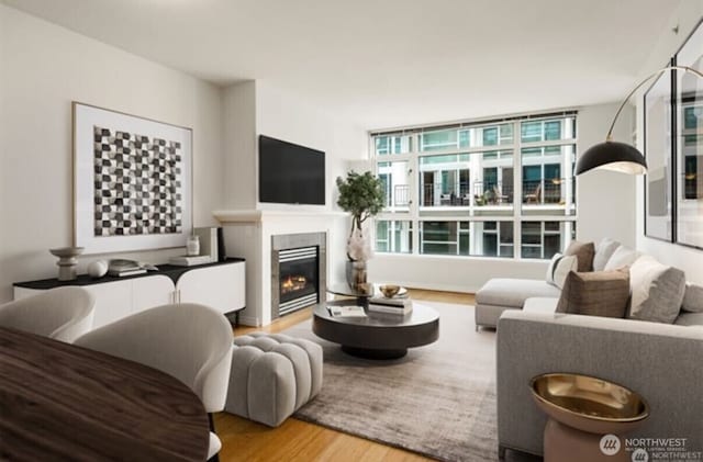 1420 Terry Ave Unit 907, Seattle, WA 98101 - living room featuring wood finished floors and a glass covered fireplace