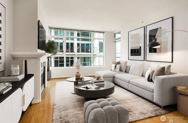 1420 Terry Ave Unit 907, Seattle, WA 98101 - living room featuring light wood-type flooring and a fireplace
