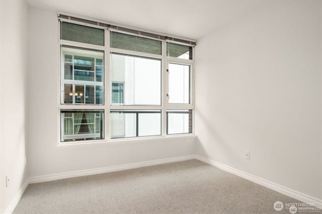 1420 Terry Ave Unit 907, Seattle, WA 98101 - spare room featuring carpet floors and baseboards