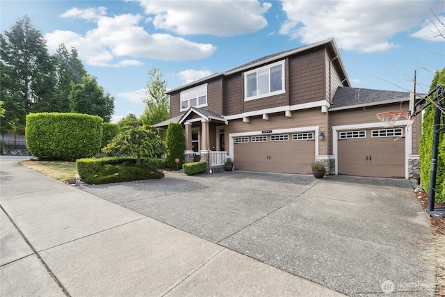 12009 31st Pl NE, Lake Stevens, WA 98258 - view of front of home with driveway, stone siding, and a garage