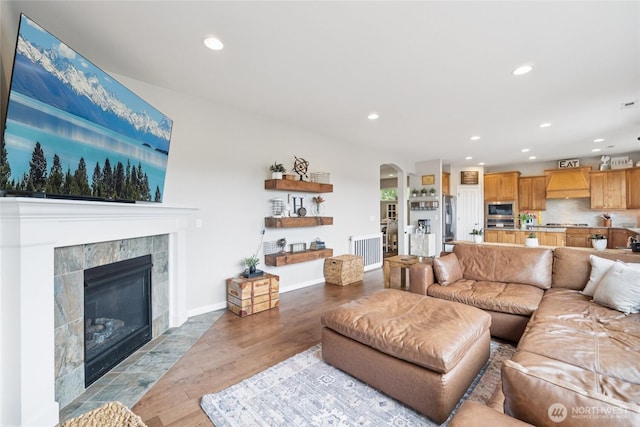 12009 31st Pl NE, Lake Stevens, WA 98258 - living area with recessed lighting, arched walkways, light wood finished floors, and a fireplace