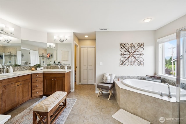 12009 31st Pl NE, Lake Stevens, WA 98258 - bathroom featuring double vanity, a bath, tile patterned flooring, and a shower with door