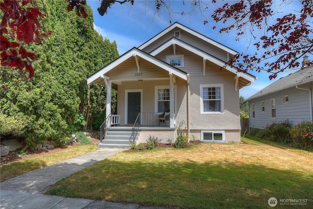3207 N 9th St, Tacoma, WA 98406 - view of front facade with covered porch, a front lawn, and stucco siding