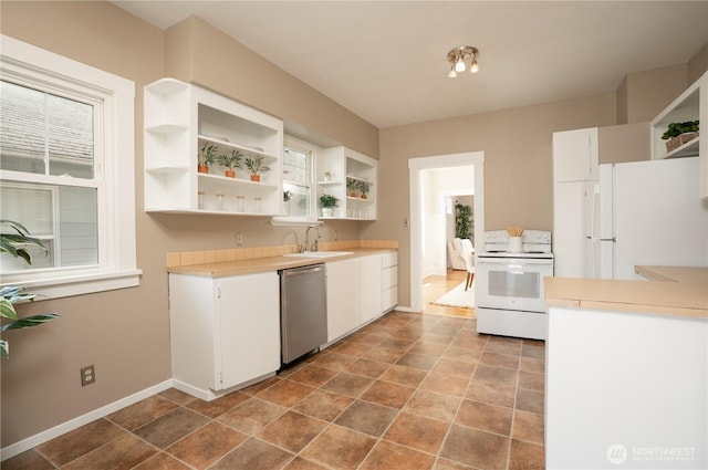 3207 N 9th St, Tacoma, WA 98406 - kitchen featuring white appliances, open shelves, light countertops, white cabinetry, and stone finish floors