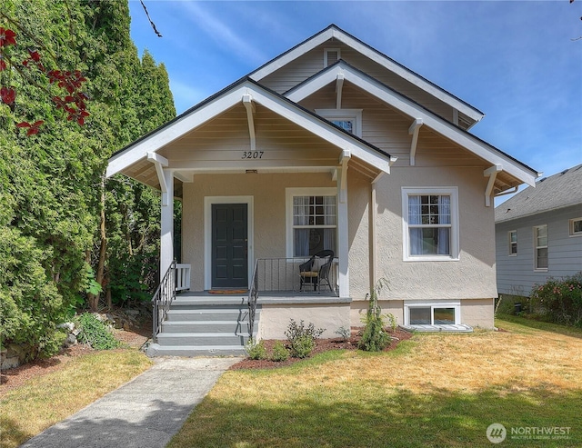 3207 N 9th St, Tacoma, WA 98406 - bungalow-style home featuring a front lawn, covered porch, and stucco siding