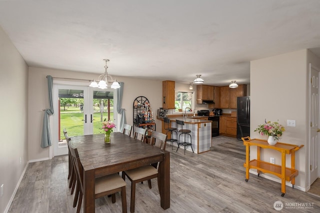 7649 Mcdougal Ave NE, Moses Lake, WA 98837 - dining room featuring light wood finished floors, french doors, and a chandelier