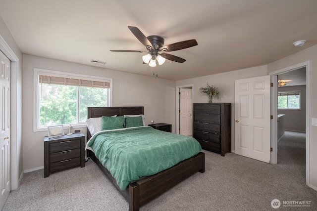 7649 Mcdougal Ave NE, Moses Lake, WA 98837 - bedroom with light carpet, multiple windows, and ceiling fan
