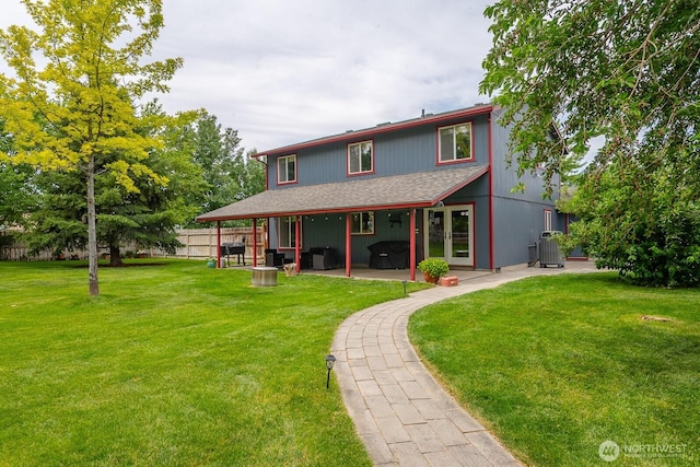 7649 Mcdougal Ave NE, Moses Lake, WA 98837 - rear view of property featuring a patio area, a yard, and a shingled roof
