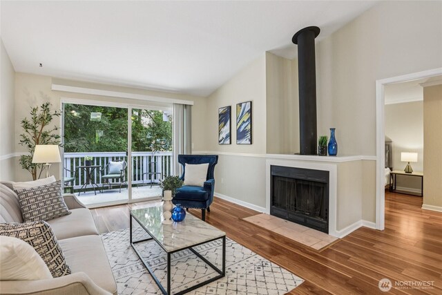 13145 102nd Ln NE Unit 6, Kirkland, WA 98034 - living room with wood finished floors, a fireplace with flush hearth, and lofted ceiling